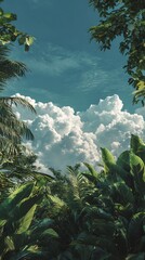 Majestic mountain peaks emerge from lush green foliage under a vast cloud filled sky