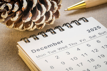 December 2025 - small spiral desktop calendar, time and business concept