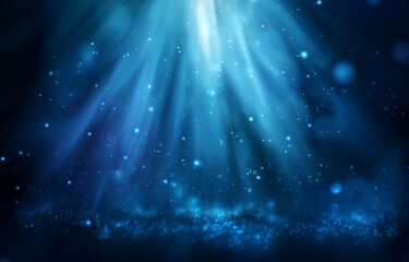 Deep blue underwater light rays and sparkling particles background abstract bokeh