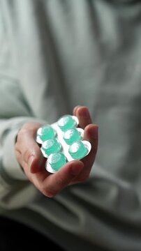 Throat lozenges for a sore throat.
A person holding a blister pack of throat lozenges.
Medicine, health, lozenge, blister, strip, pharmaceuticals
