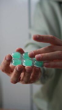 A person holding a blister pack of mint throat lozenges.
Menthol lozenges or tablets.
Sore throat relief and prevention during a sore throat.