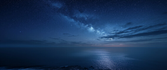 Vast dark blue ocean under a starry night sky with the Milky Way and moonlit water reflections stars