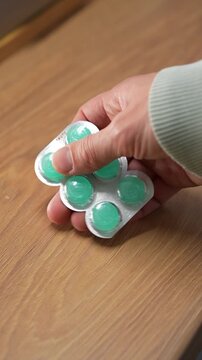 Throat lozenges for a sore throat.
A person holding a blister pack of throat lozenges.
Medicine, health, lozenge, blister, strip, pharmaceuticals