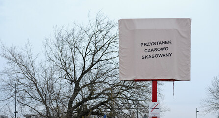 Covered bus stop sign with text 