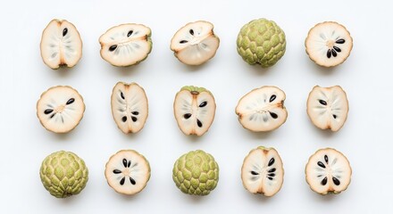 Obraz premium Fresh Custard Apples on a White Surface with Sections of Cut Fruit Arrayed