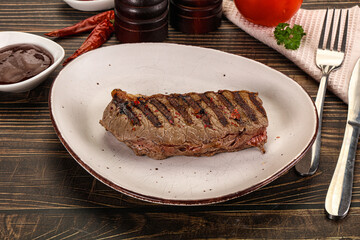 Grilled beef striploin steak with sauce