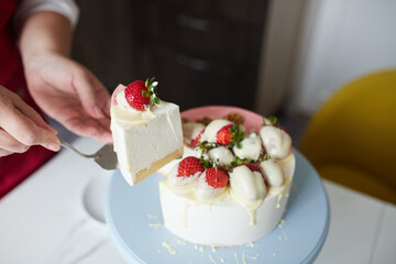 Making a cake with white and pink chocolate strawberries. High quality photo