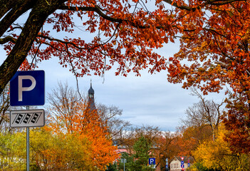 Late autumn colors. Local street in Jurmala leading to the   old church