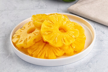 Sweet canned pineapple slices in syrope
