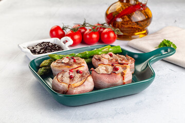 Tasty grilled pork medallion with bacon