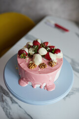 Making a cake with white and pink chocolate strawberries. High quality photo