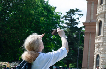 A female tourist takes a photo of the ancient Mokshan Castle in Polan