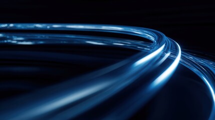 An abstract representation of light trails flowing dynamically in various shades of blue against a dark background, creating a sense of depth and movement.