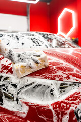 Hand car wash detailing sponge stage removes dirt and debris, leaving the car paint smooth and glossy. Sponge washing to clean every panel without scratching or damaging the paint.