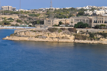 The historic Bighi Complex in Kalkara, Malta, featuring imposing architecture and coastal views along Triq Marina. Cultural heritage of Malta