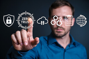 Man interacts with zero trust security interface showcasing cybersecurity cloud computing data protection and global network management in a modern digital environment for business solutions