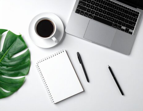 Overhead View of Minimalist Work Desk with Laptop, Coffee, and Notebook