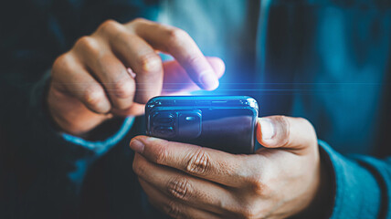 Person interacts with a smartphone showcasing mobile technology and digital lifestyle highlighting connectivity communication and modern device usage in a contemporary setting