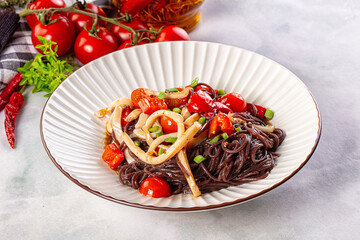 Black rice pasta with squid and tomato