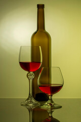Still life with glass bottle and wine glasses