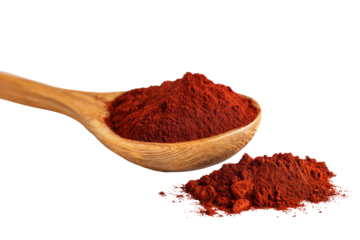Wooden spoon holding a pile of vibrant red powder, with additional powder scattered below