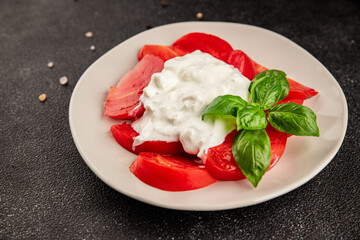 Salad strachatella and tomato portion size natural product tasty snack fresh delicious gourmet food background on the table rustic top view copy space keto and paleo diet