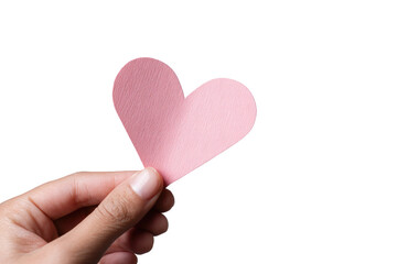Fototapeta premium A hand holds a pale pink paper heart