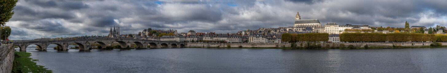 Blois, France - 10 26 2025: Panoramic view of the cityscape, La Loire river, bridge Jacques Gabriel, Saint-Louis Cathedral, Saint Nicholas church from port of Creusille