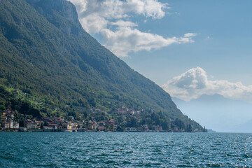 Fototapeta premium Beautiful landscape of lake Como in Varenna , Italy with green mountains, blue water and white clouds