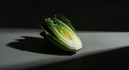 Freshly Cut Lettuce Displaying Textural Details And Elegant Contrast Shadows On Gray Surface