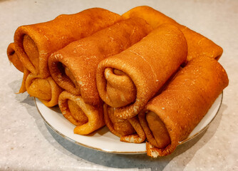 A plate of pancakes sits on the table.
