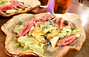 A plate of food with meat and lettuce