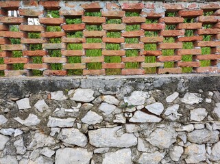 Patchwork Mediterranean Fence: A Blend of UNESCO Stone and Modern Red Brick
