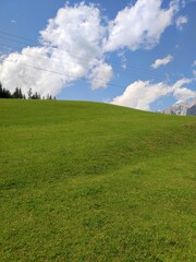 Electrical Power Lines Crossing a Lush Mountain Pasture in Austria