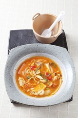 A Korean-style army stew made with willow milky mushrooms, sausage, tofu, and kimchi simmered in a spicy broth for a rich and hearty flavor. Created by Master Chef Hanshunseop. Photographed in Korea.