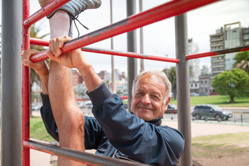 Smiling senior man doing stretches training.