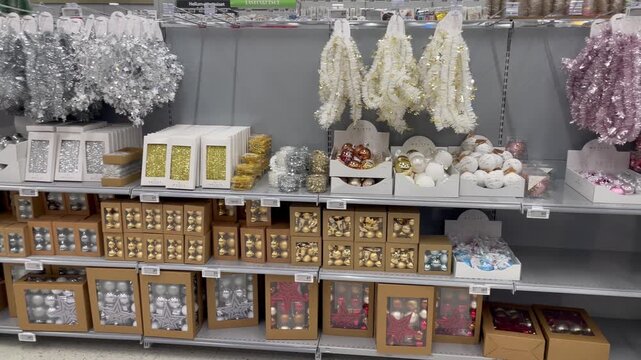 Store shelves filled with christmas balls tinsel and decorations create a festive holiday atmosphere bright shiny ornaments reflect light reminding of cozy winter evenings and celebration