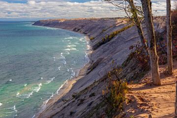 view of sand dune on shore of lake.
