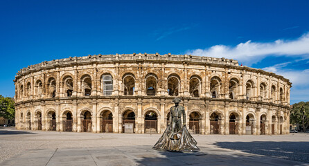 N&icirc;mes, Provence, France &ndash; Exterior of the Arena of N&icirc;mes with the statue of a bullfighter (torero).