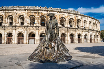 N&icirc;mes, Provence, France &ndash; Exterior of the Arena of N&icirc;mes with the statue of a bullfighter (torero).