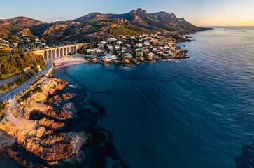 Aerial panoramic view of the Antheor Viaduct in the Esterel Mountains near Saint Raphael, French Riviera, overlooking the Mediterranean Sea and luxury villas along the Cote dAzur coastline at sunrise