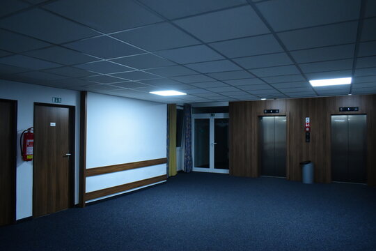 empty corridor in a hotel with elevators and an exit