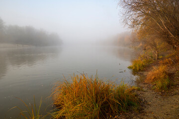 Foggy dawn in autumn by the river.