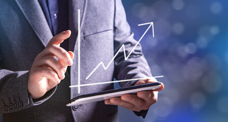 hand holding a chart with an arrow pointing up