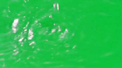 Water drops falling on a vibrant green screen creating ripples and splashes perfect for compositing and visual effects in various creative projects and backgrounds. - Powered by Adobe