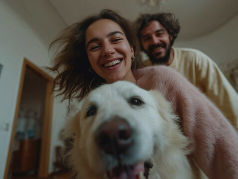 Joyful couple smiles with their beloved golden retriever creating happy family moments.