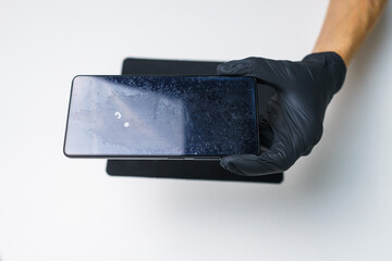 A smartphone with a badly worn screen protector.