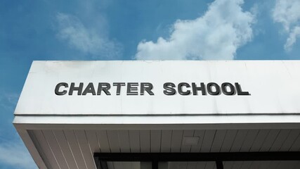 Charter School word sign clearly displayed on the modern, educational facade of a facility beneath a bright blue sky, signifying a publicly funded, independently operated school focusing on specialize