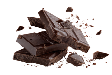 Dark chocolate pieces and shards scattered around a stack of broken chocolate bars
