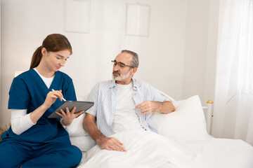 Obraz premium Home healthcare service for seniors with female nurse checking elderly man's heartbeat using stethoscope. Ideal for medical care, elder support, home visit, and heart health visuals.